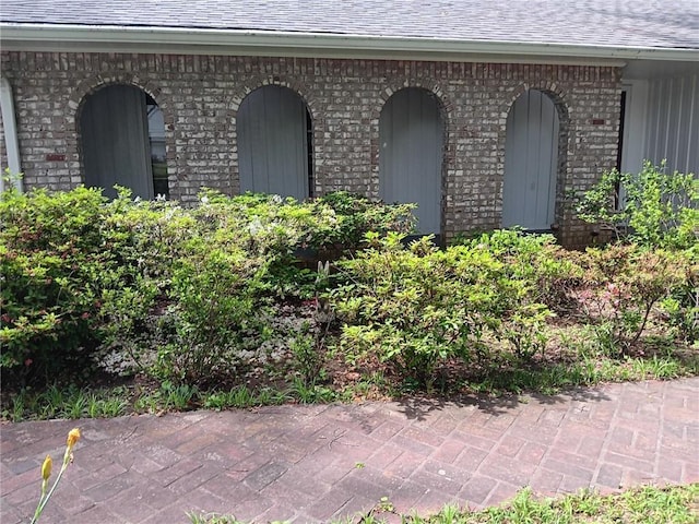 2479 Kingsland Dr, Dunwoody, GA 30360 - view of exterior entry with brick siding and a shingled roof