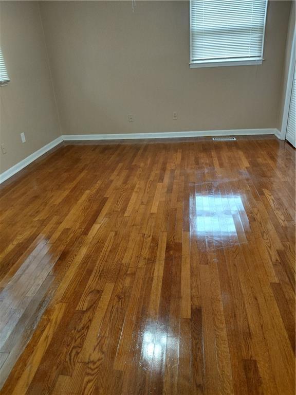2479 Kingsland Dr, Dunwoody, GA 30360 - empty room featuring hardwood / wood-style floors and baseboards