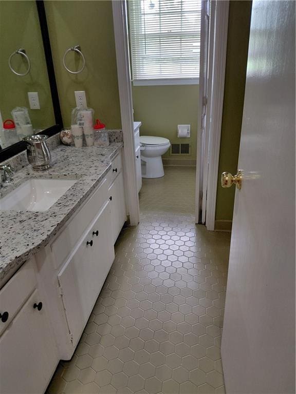 2479 Kingsland Dr, Dunwoody, GA 30360 - bathroom with vanity, toilet, and tile patterned flooring