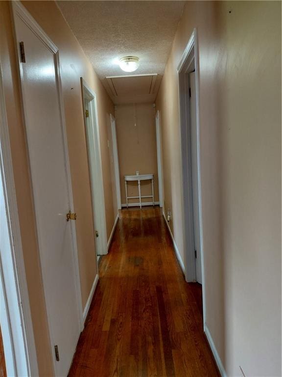 2479 Kingsland Dr, Dunwoody, GA 30360 - corridor with attic access, wood finished floors, a textured ceiling, and baseboards