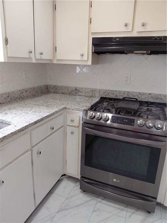 2479 Kingsland Dr, Dunwoody, GA 30360 - kitchen featuring gas range, ventilation hood, light marble finish floors, tasteful backsplash, and white cabinets