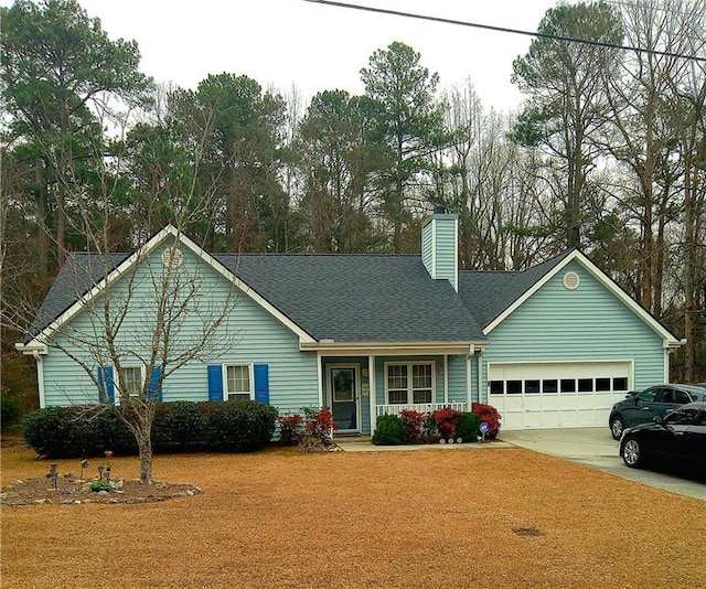 view of front of home with a garage and a front yard