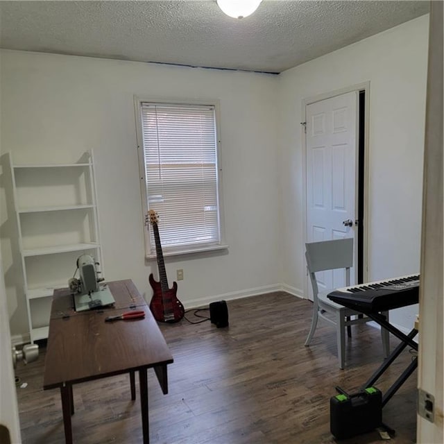 office with baseboards, a textured ceiling, and wood finished floors