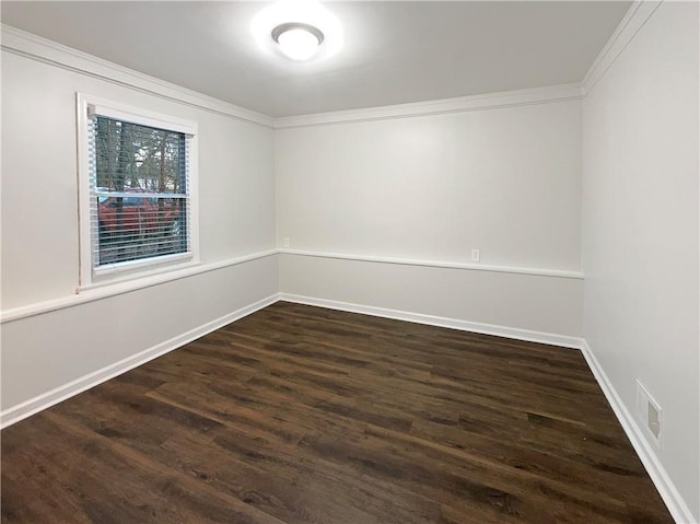 empty room with ornamental molding and dark hardwood / wood-style floors