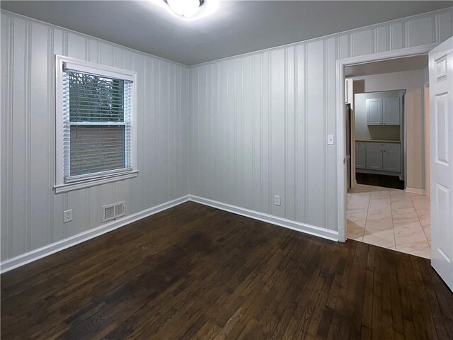 empty room with hardwood / wood-style flooring