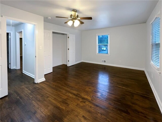 interior space with ceiling fan and dark hardwood / wood-style floors