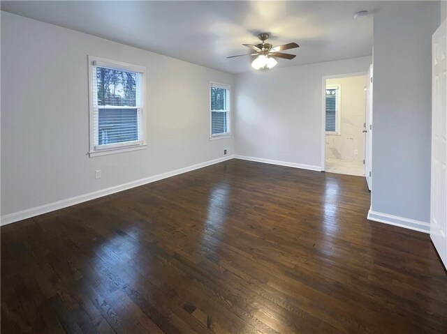 spare room featuring ceiling fan, plenty of natural light, and dark hardwood / wood-style flooring