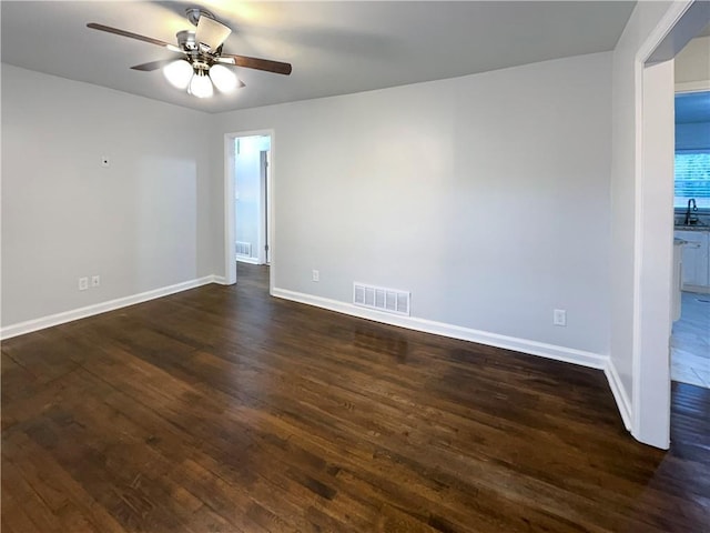 empty room featuring ceiling fan and dark hardwood / wood-style floors