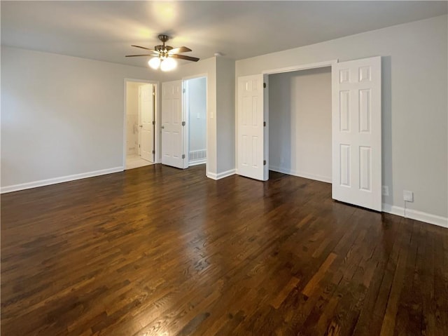 unfurnished bedroom featuring ceiling fan and dark hardwood / wood-style flooring
