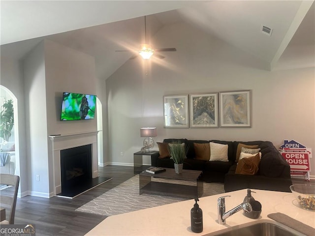 living room with ceiling fan, high vaulted ceiling, sink, and dark hardwood / wood-style flooring