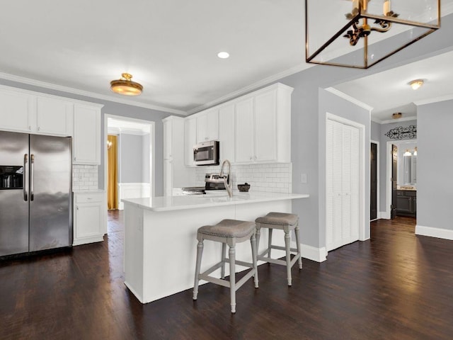 kitchen with crown molding, tasteful backsplash, and stainless steel appliances