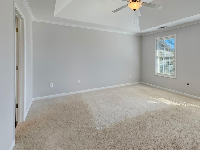 empty room featuring baseboards, ornamental molding, ceiling fan, and carpet