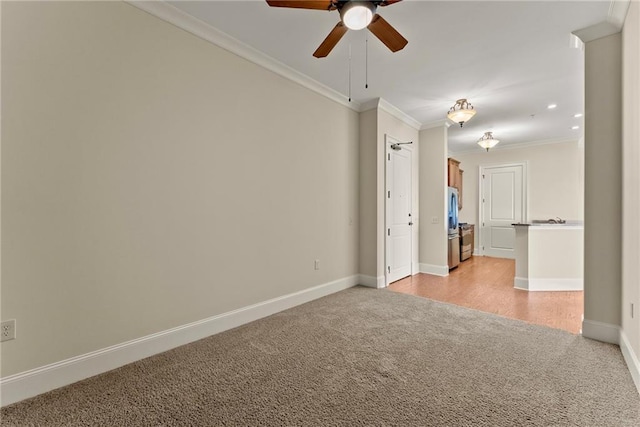 empty room with light colored carpet, ornamental molding, and ceiling fan