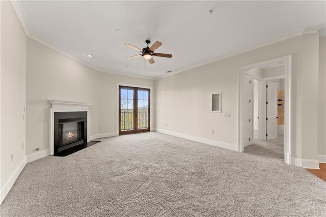 unfurnished living room featuring ceiling fan, light colored carpet, and ornamental molding