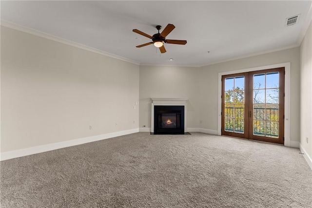 unfurnished living room featuring crown molding, ceiling fan, and carpet