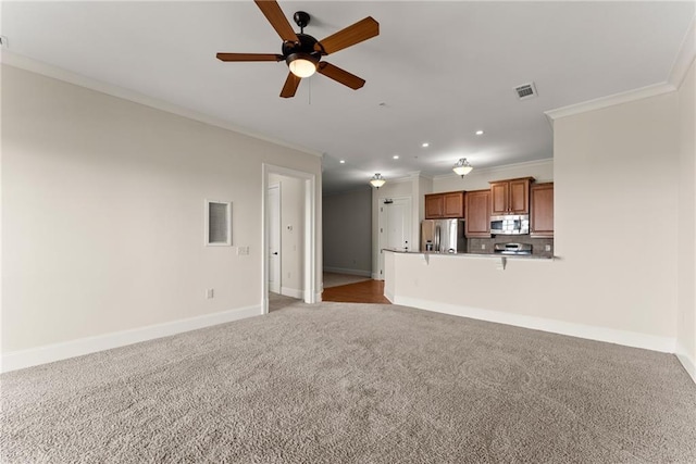 unfurnished living room with ornamental molding, light carpet, and ceiling fan