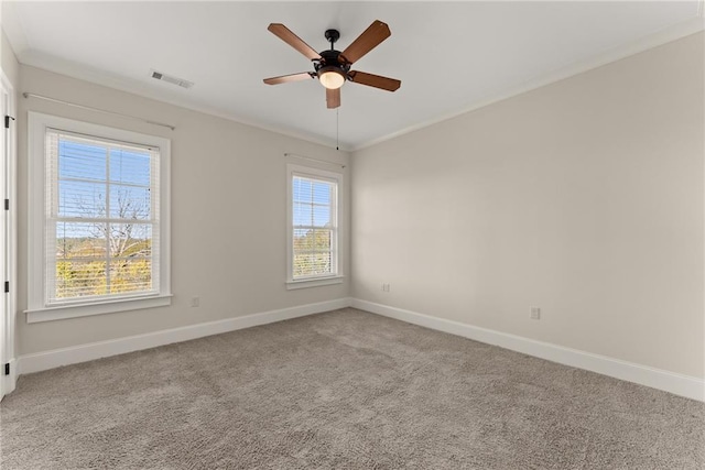 carpeted spare room featuring crown molding and ceiling fan