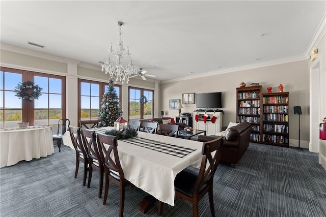 carpeted dining room with an inviting chandelier and ornamental molding