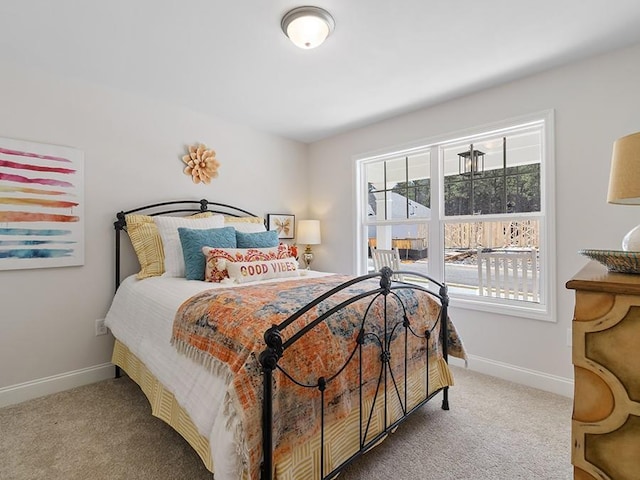 bedroom with carpet floors and baseboards