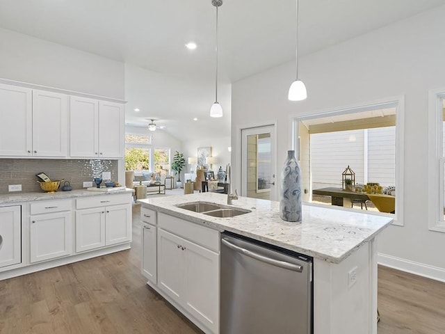 kitchen featuring decorative light fixtures, white cabinetry, an island with sink, and stainless steel dishwasher