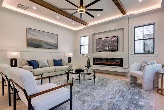136 Beutell St, Norcross, GA 30071 - living area with light wood-style floors, ceiling fan, a glass covered fireplace, beamed ceiling, and recessed lighting