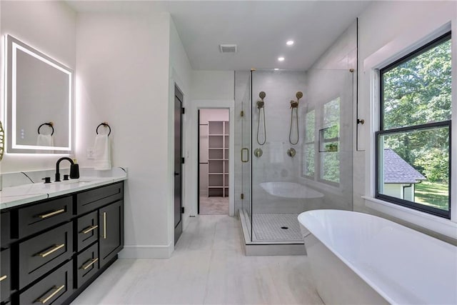136 Beutell St, Norcross, GA 30071 - full bathroom with a stall shower, vanity, a soaking tub, a spacious closet, and recessed lighting