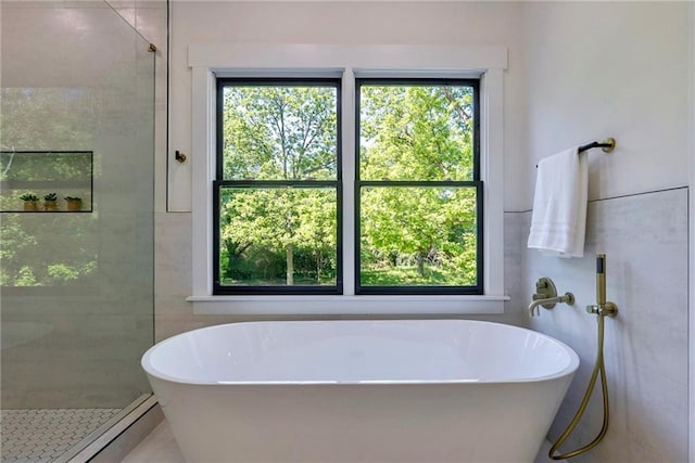 136 Beutell St, Norcross, GA 30071 - bathroom with plenty of natural light, a stall shower, a freestanding tub, and tile walls