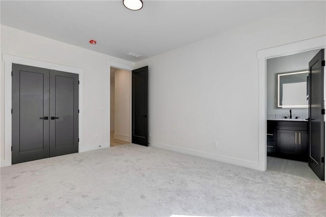 136 Beutell St, Norcross, GA 30071 - unfurnished bedroom featuring light carpet, baseboards, a closet, and connected bathroom