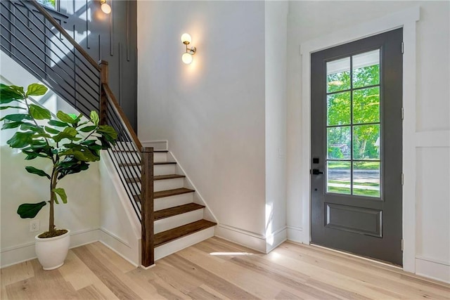 136 Beutell St, Norcross, GA 30071 - foyer entrance with light wood-style floors, stairway, and baseboards