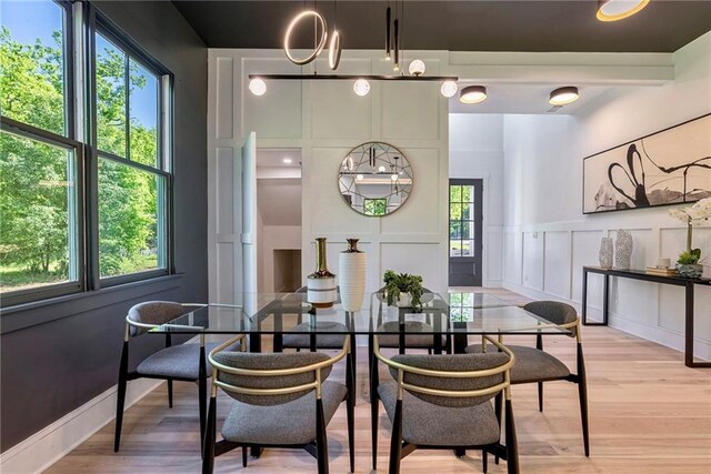 136 Beutell St, Norcross, GA 30071 - dining area featuring a decorative wall, light wood-style floors, and wainscoting