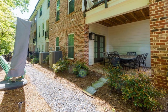 451 Burton Dr Unit 32, Alpharetta, GA 30009 - view of patio featuring central AC and fence