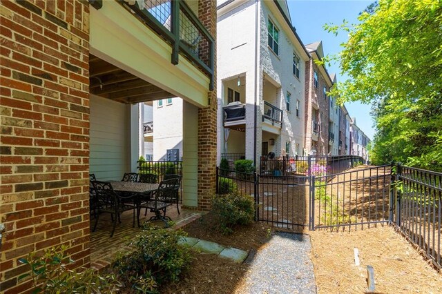 451 Burton Dr Unit 32, Alpharetta, GA 30009 - view of patio featuring fence and outdoor dining area