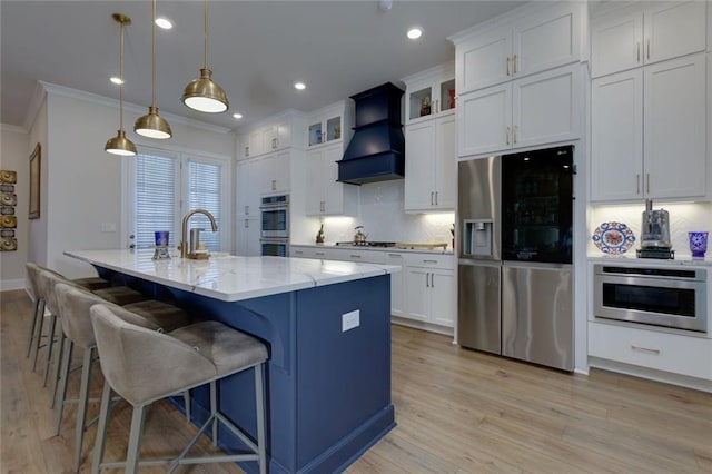 451 Burton Dr Unit 32, Alpharetta, GA 30009 - kitchen with appliances with stainless steel finishes, custom exhaust hood, ornamental molding, backsplash, and white cabinets