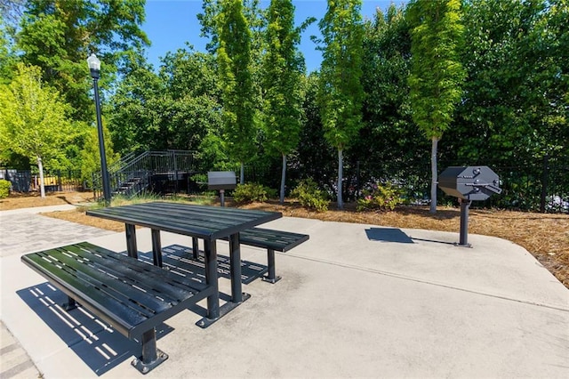 451 Burton Dr Unit 32, Alpharetta, GA 30009 - view of property's community with a patio, fence, stairway, and view of wooded area