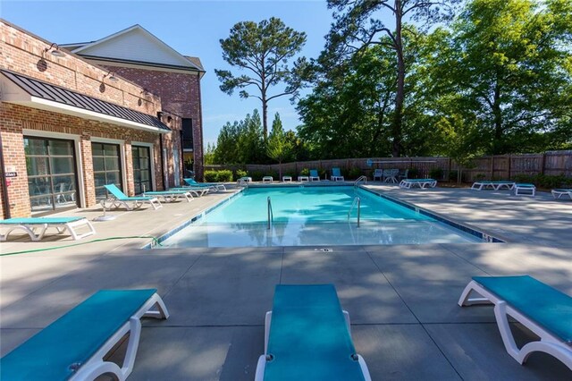 451 Burton Dr Unit 32, Alpharetta, GA 30009 - community pool featuring a patio area and fence