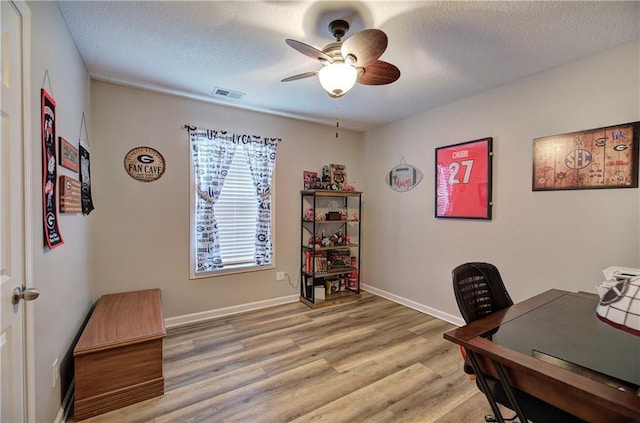 office area featuring ceiling fan, a textured ceiling, and light wood-type flooring