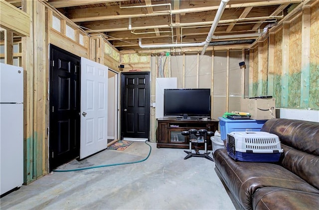 basement featuring white fridge