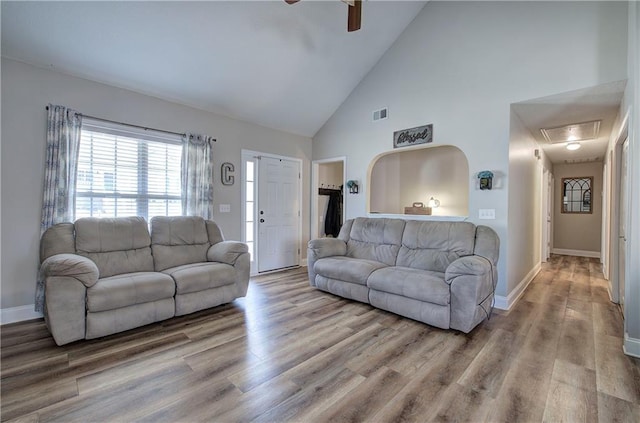 living room featuring wood-type flooring, ceiling fan, and high vaulted ceiling