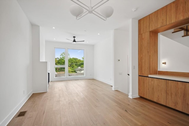 interior space featuring light wood-style flooring, baseboards, visible vents, recessed lighting, and a ceiling fan