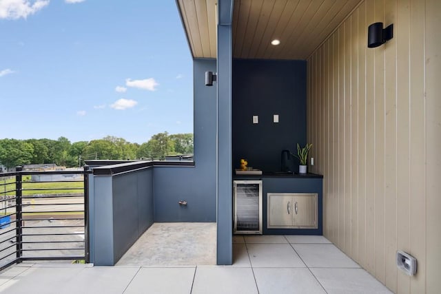 balcony featuring beverage cooler and a sink