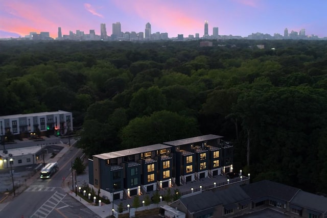 birds eye view of property featuring a city view and a forest view