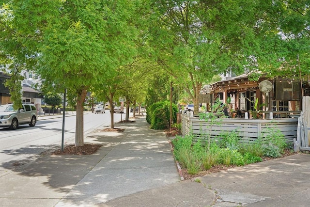 view of home's community featuring fence
