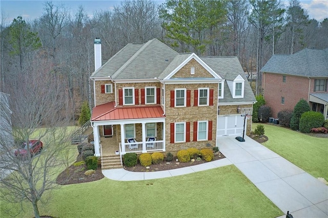 view of front of home with a porch, a garage, and a front lawn