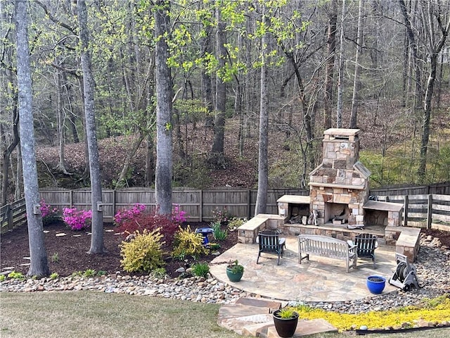 view of patio with an outdoor stone fireplace