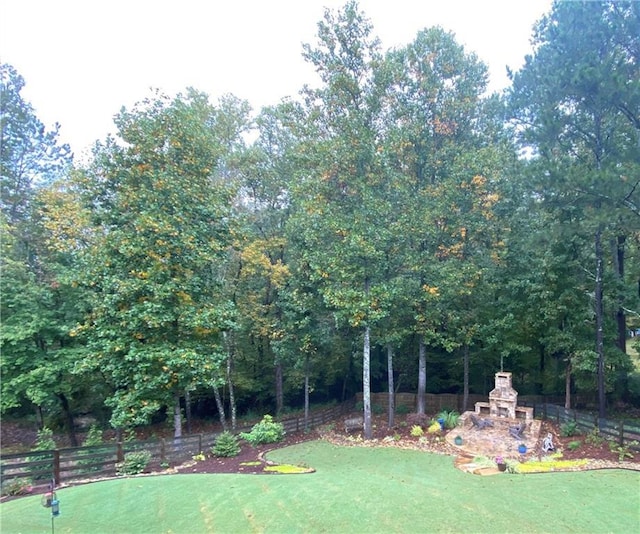 view of yard with an outdoor fireplace