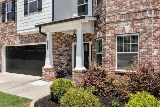 4171 Towncastle Ln, Buford, GA 30518 - property entrance with a garage, brick siding, and concrete driveway