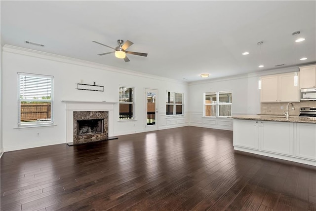 4171 Towncastle Ln, Buford, GA 30518 - unfurnished living room featuring ceiling fan, ornamental molding, a fireplace, dark wood finished floors, and recessed lighting