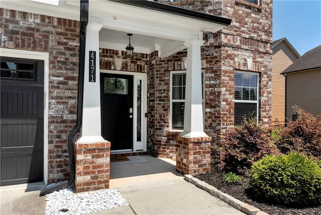 4171 Towncastle Ln, Buford, GA 30518 - doorway to property featuring brick siding, a porch, and a garage