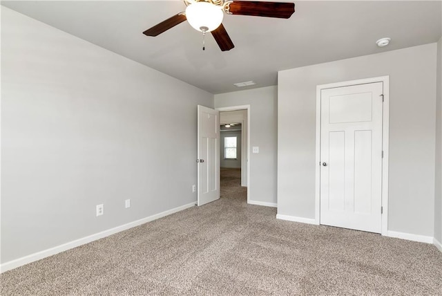 4171 Towncastle Ln, Buford, GA 30518 - unfurnished bedroom featuring carpet floors, baseboards, and a ceiling fan
