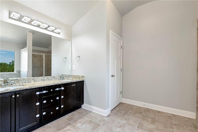 4171 Towncastle Ln, Buford, GA 30518 - full bath with double vanity, a shower stall, baseboards, and lofted ceiling